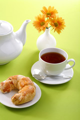 Breakfast concept with coffee and croissant