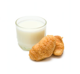 Glass with milk and cakes on plate