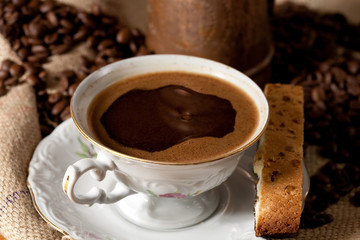 Cup of coffee and biscotti cookie