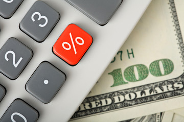 dollars and calculator with percent red button