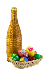 Basket with easter eggs and wicker bottle