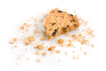 Last bite of a chocolate chip cookie with crumbs - obrazy, fototapety, plakaty