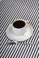 Coffee cup on the striped surface