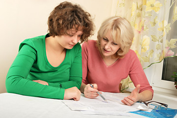 Adult and young women with documents