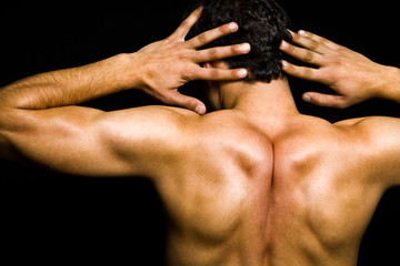 Obraz na płótnie Canvas Artistic pose - back of muscular man