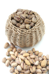 It is a lot of nuts in a basket on a white background