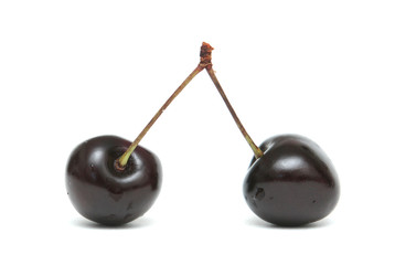 Two berries of a sweet cherry on a white background