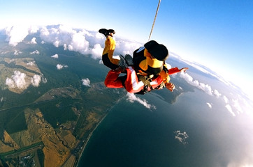 Skydivers over coast