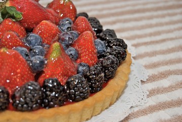 Fresh fruit tart glazed with sweetened gelatin.