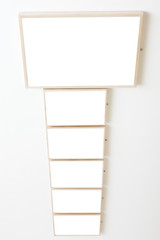 Six empty frames on white wall exhibition