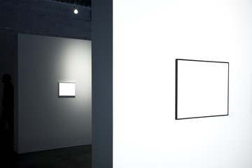 Empty frames on white wall