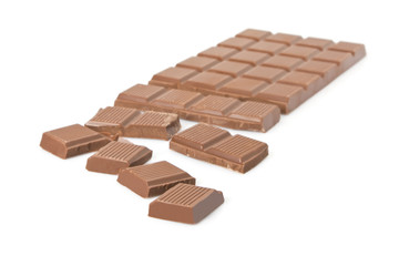 Broken milk chocolate bar isolated on white background