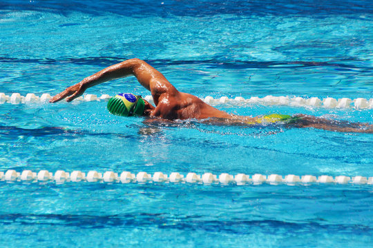 Swimmer crowls in pool