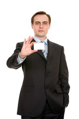 Young businessman showing a businesscard. Isolated on white.