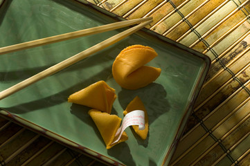 Fortune Cookies and Chopsticks on a green plate and bamboo - 11982263