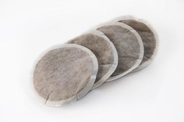 four coffee pads on a row