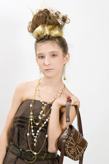 Fashion girl showing jewels and handbag