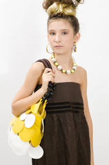 Fashion girl showing jewels and handbag