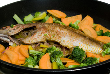 Fish and vegetables on the frypan