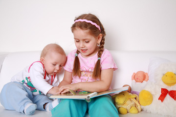 Adorable kids reading and playing