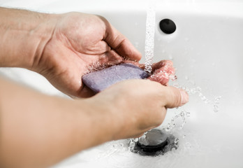 Fototapeta premium person's hands washing under tap