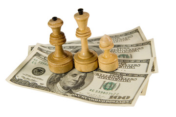 Chess figures (white king, queen and pawn) on US dollars