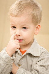 Boy with finger in the nose