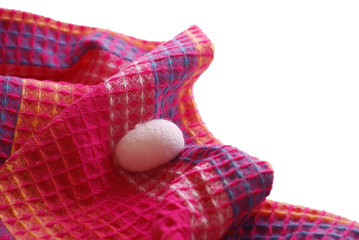 Silk cocoon laying on magenta cloth