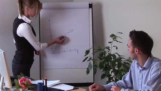 Businesswoman in a meeting explaining a graph