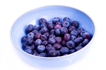 A blue bowl filled with fresh blueberries