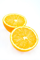 A pair of halved orange sections on white
