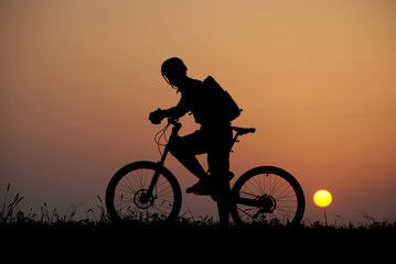 Fototapeta premium mountain biker silhouette in sunrise