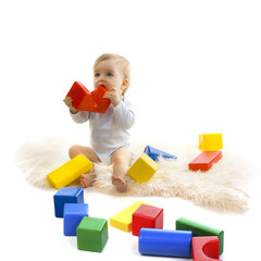 Baby playing with bright blocks