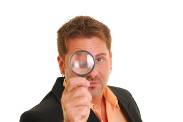 Business man holding a magnifying glass