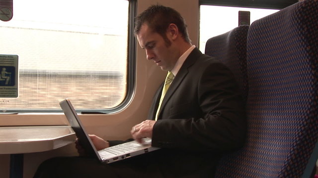 Handsome businessman working in a train
