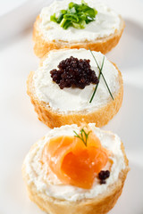 Mini sandwiches - bagel with cream cheese, salmon, caviar