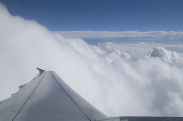 Naklejka na ściany i meble Flying over the clouds