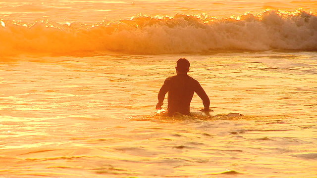 Surfers At Sunset
