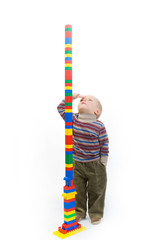 little boy look on the blocks tower