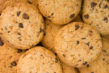 Pile of chocolate chip cookies isolated on white background.