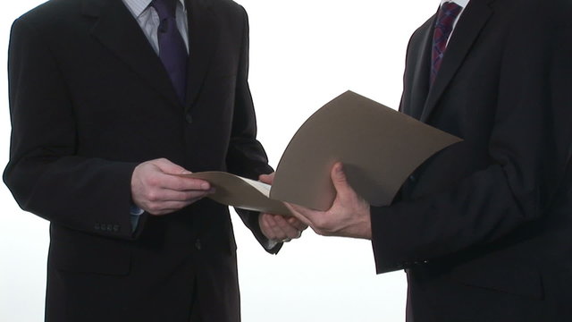 Two Businessmen Reviewing an important document