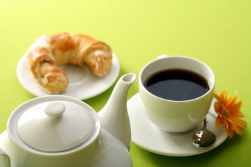 Breakfast concept with coffee and croissant