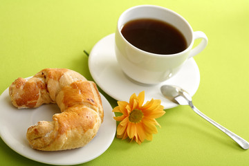 Breakfast concept with coffee and croissant