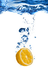 Fototapeta na wymiar Fresh lemon dropped into water with bubbles isolated on white