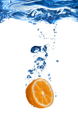 Fototapeta na wymiar Fresh orange dropped into water with bubbles isolated on white