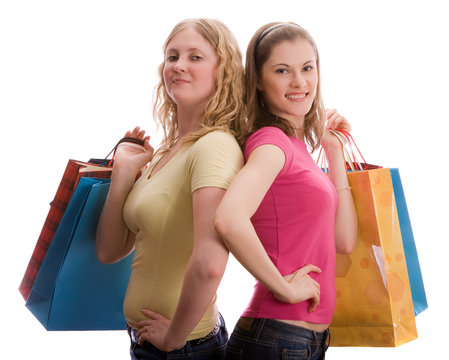 Two beautiful girls with shopping bags. Isolated on white.