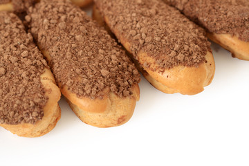 Close-up of four fresh eclairs isolated on white background