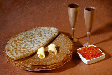 Pancakes with fish red caviar, butter and vodka