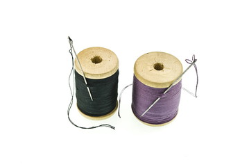 a spools of thread with a needles in it