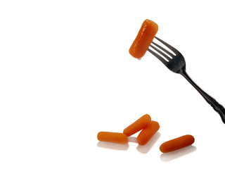 Carrot on Fork over Carrots on White